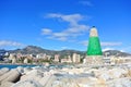 A view to Mediterranean sea, a lighthouse with breakwaters and hotels at the background from a pier at Benalmadena