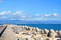 A view to Mediterranean sea, a lighthouse with breakwaters and Torremolinos from a pier Royalty Free Stock Photo