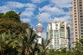 View to the Menara Tower or KL tower through the palm trees of the KLCC park