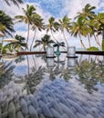 a view to an ocean with coconut palms and beach umbrellas with reflection on a cafe table's glass Royalty Free Stock Photo