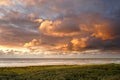 View to the ocean at sunset. The clouds are illuminated by the sun. North Holland dune reserve, Egmond aan Zee, Netherlands Royalty Free Stock Photo