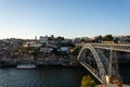 View to the old city of Porto with the D. Luis bridge and colorful buildings. Warm golden light