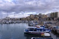 View to the old Venetian port with the traditional fishing boats and the Heraklion city with the old Venetian shipyards Royalty Free Stock Photo