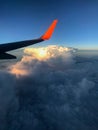 View to the plain wing clouds earth sea mountains from the airplane window Royalty Free Stock Photo