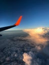 View to the plain wing clouds earth sea mountains from the airplane window