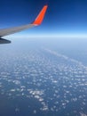 View to the plain wing clouds earth sea mountains from the airplane window Royalty Free Stock Photo