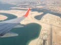 View to the plain wing clouds earth sea mountains from the airplane window Royalty Free Stock Photo