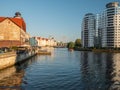 View to Pregolya river with "Fish Village" old town on one side and modern buildings on other side.