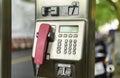 View to a public phone with telephone receiver, dial buttons, display and payment unit for coins and card payment Royalty Free Stock Photo