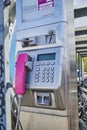 View to a public phone with telephone receiver, dial buttons, display and payment unit for coins and card payment Royalty Free Stock Photo