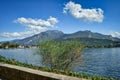 view to Riva del Garda, mountains, Monte Brione, lake, water, pier, promenade, blue sky