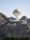 View to the Riyam Park monument dome through the palm leaves. Muscat, Oman. Royalty Free Stock Photo