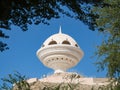 View to the Riyam Park monument dome through the palm leaves. Muscat, Oman. Royalty Free Stock Photo