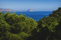 View to the rock of Calpe `Ifach` over mediterranean sea and blurred pines at natural park `Serra Gelada` in Albir, Spain Royalty Free Stock Photo