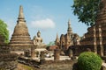 View to the ruins and sitting Buddha statue at Wat Mahathat temple in Sukhothai Historical Park, Thailand. Royalty Free Stock Photo