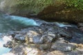 View to scenic mountain river with rapid and noisey stream of turquoise-blue water and growing trees on rocks in natural in Bali. Royalty Free Stock Photo