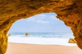 View to the sea beach from inside a cave Royalty Free Stock Photo