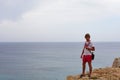 View to the sea, Cyprus, Protaras, May 2018. Beautiful blue sea. Rocks and mountains. A man stands on the edge of a rock and looks