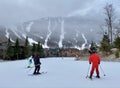 View to the ski slopes and skiers going down during Beautiful snow day