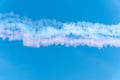 View to the sky with colorful smoke clouds, red, blue and white, produced by airplanes. Nice background for decoration. Royalty Free Stock Photo