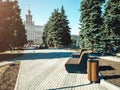 View to South Ural State University in Chelyabinsk at summer day with people sitting on the bench among the trees