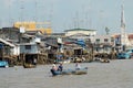 View to the stilt houses and people crossing river by boat in Cai Be, Vietnam. Royalty Free Stock Photo