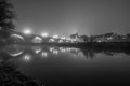 View to the stone bridge in Regensburg at night in the fog over the river Danube with the illuminated cathedral and historical old Royalty Free Stock Photo