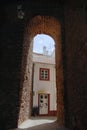 View to the street with historical building trough an arch in Silves, Portugal.