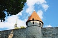 A view to Tallin Old Town walls with a tower and steeple of Saint Nicholas Church at the background, Estonia. Royalty Free Stock Photo