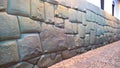 View to Twelve-angled stone aka Hatun Rumiyoc as a part of a wall of the palace of the Archbishop of Cuzco, Peru