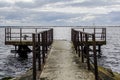 View to the white sailboat through old rusty iron pier railings Royalty Free Stock Photo