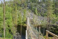 View to the wooden bridge over the canyon lake Julma-Olkky, Hossa National Park Royalty Free Stock Photo