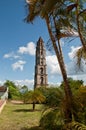 A view on tobacco plantation, Cuba. Tall tower and palm trees. Royalty Free Stock Photo