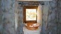 View into toilette room with natural stone wall mediterranean style, roll toilette paper in basket, window with bright natural Royalty Free Stock Photo