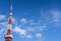 View of Tokyo tower with blue sky and airplane with cloud condensation trails in the background with copy space in Japan winter Royalty Free Stock Photo