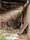 View of the tools and assorted objects in a rustic and very deteriorated small shed