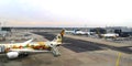 View from top at angle to inner space of Frankfurt Airport.Several aircraft,one connected to telescopic ladder