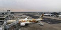 View from top at angle to inner space of Frankfurt Airport.Several aircraft,one connected to telescopic ladder