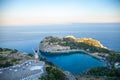 View from top on Anthony Quinn Bay and beach, Rhodes in Faliraki, Greece. Happy girl Raising One Hand. Beautiful beach and bay on