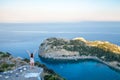 View from top on Anthony Quinn Bay and beach, Rhodes in Faliraki, Greece. Happy girl Raising One Hand. Beautiful beach and bay on