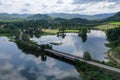 View from the top of a bridge in Thailand, surrounded by a river and various trees Royalty Free Stock Photo