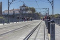 View of the top of D. Maria bridge and people walking in the Porto city