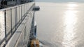 view on the top deck of the giant luxuary cruise ship from the aft area to forward with bridge view while slowly sailing into the