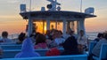 View from on top of a Fire Island Ferry boat heading into the sun setting in the horizon