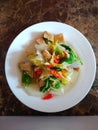 View on top fresh stir fry chinese cabbage mix tofu on a white plate