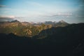 View from the top of Giewont Mountain on cliffs and mountains at sunset with a big shadow from the mountain itself