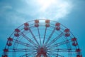 A view of the top half of a vintage Ferris Wheel fairground ride with blue sky background and copy space Royalty Free Stock Photo