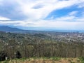 The view from the top from a height of a beautiful tourist city with buildings and houses, roofs of trees and plants, nature Royalty Free Stock Photo