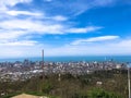 The view from the top from a height of a beautiful tourist city with buildings and houses, roofs of trees and plants, nature Royalty Free Stock Photo