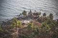 View from the top of the hill to the cliffs, palm trees and the Arabian Sea Royalty Free Stock Photo